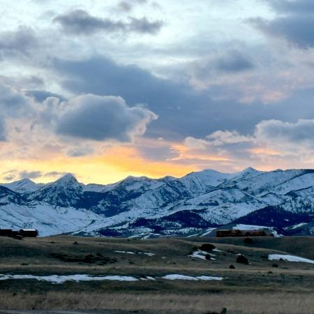 Sun behind the snowy mountains in Paradise Valley